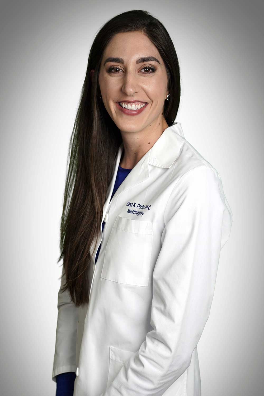 Headshot of PA Gina Porto wearing her lab coat and smiling.