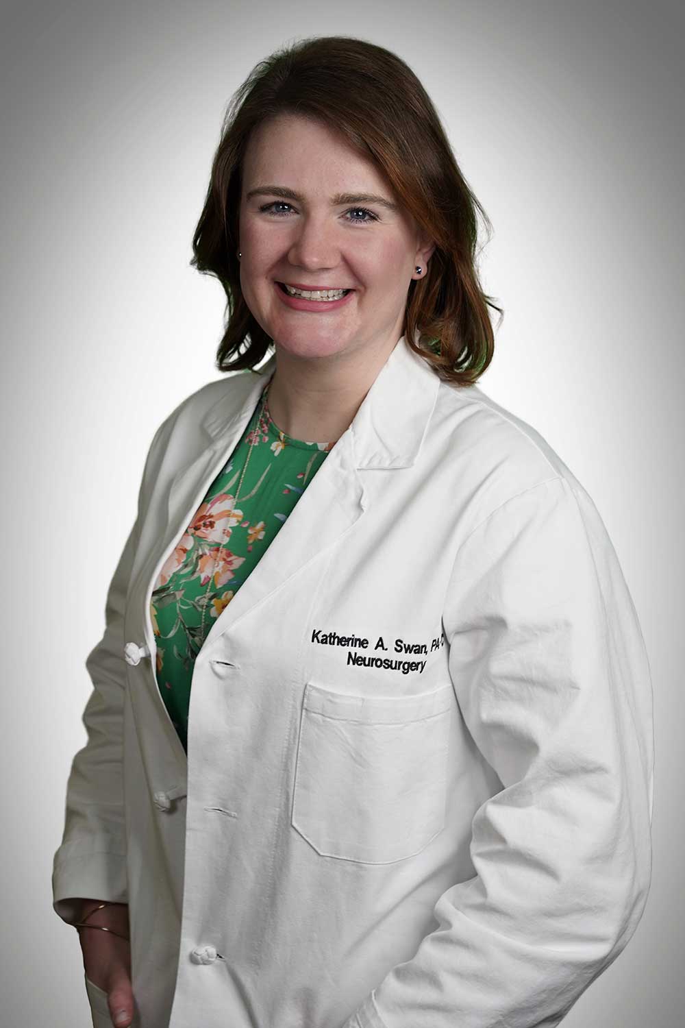 Headshot of PA Katherine Swan wearing her lab coat and smiling.