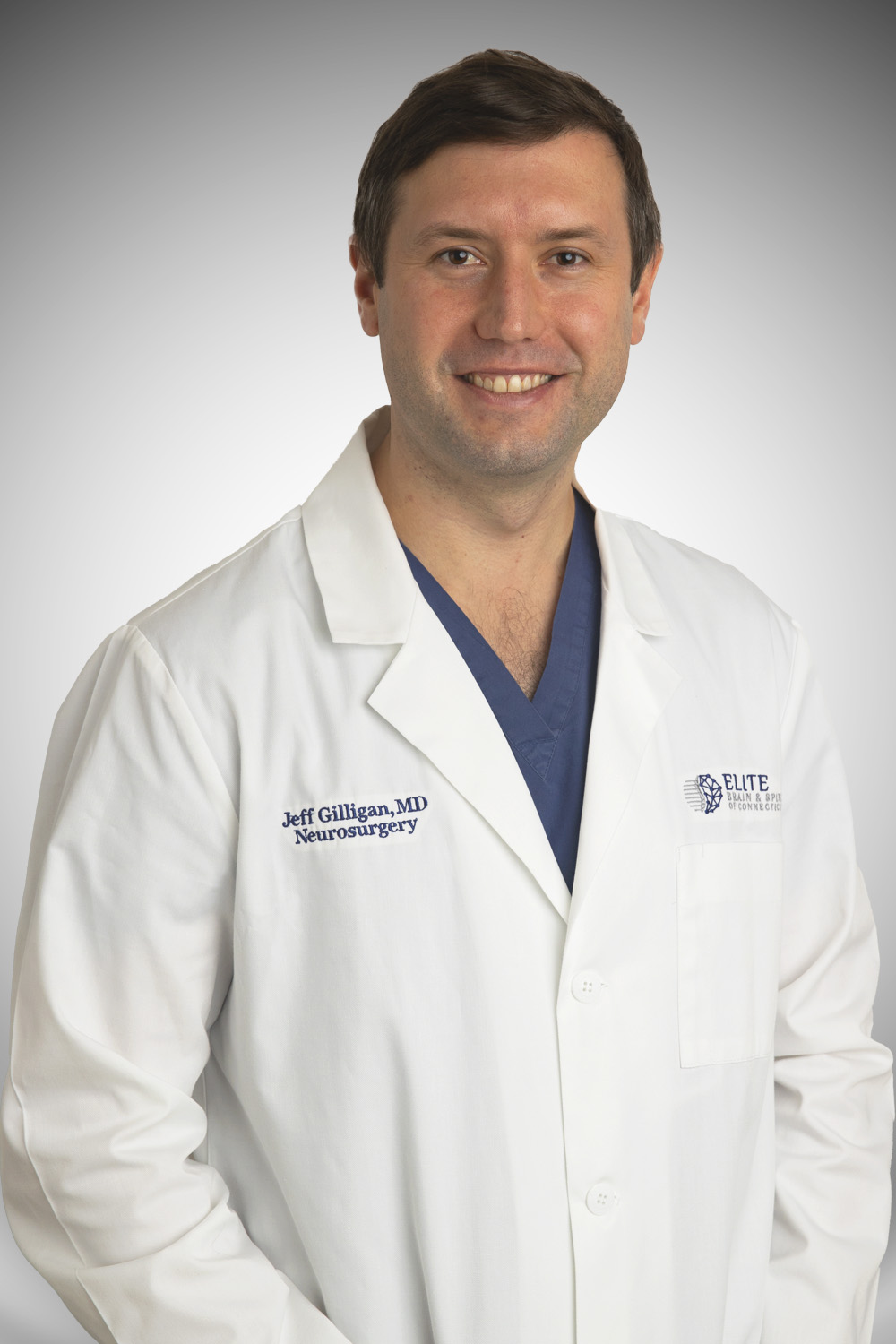 Headshot of chief neurosurgeon Scott Anderson wearing a suit and smiling.